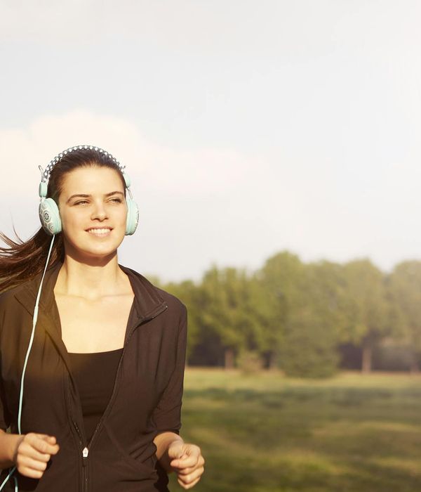 Woman feeling energetic and happy outdoors in the morning sun.